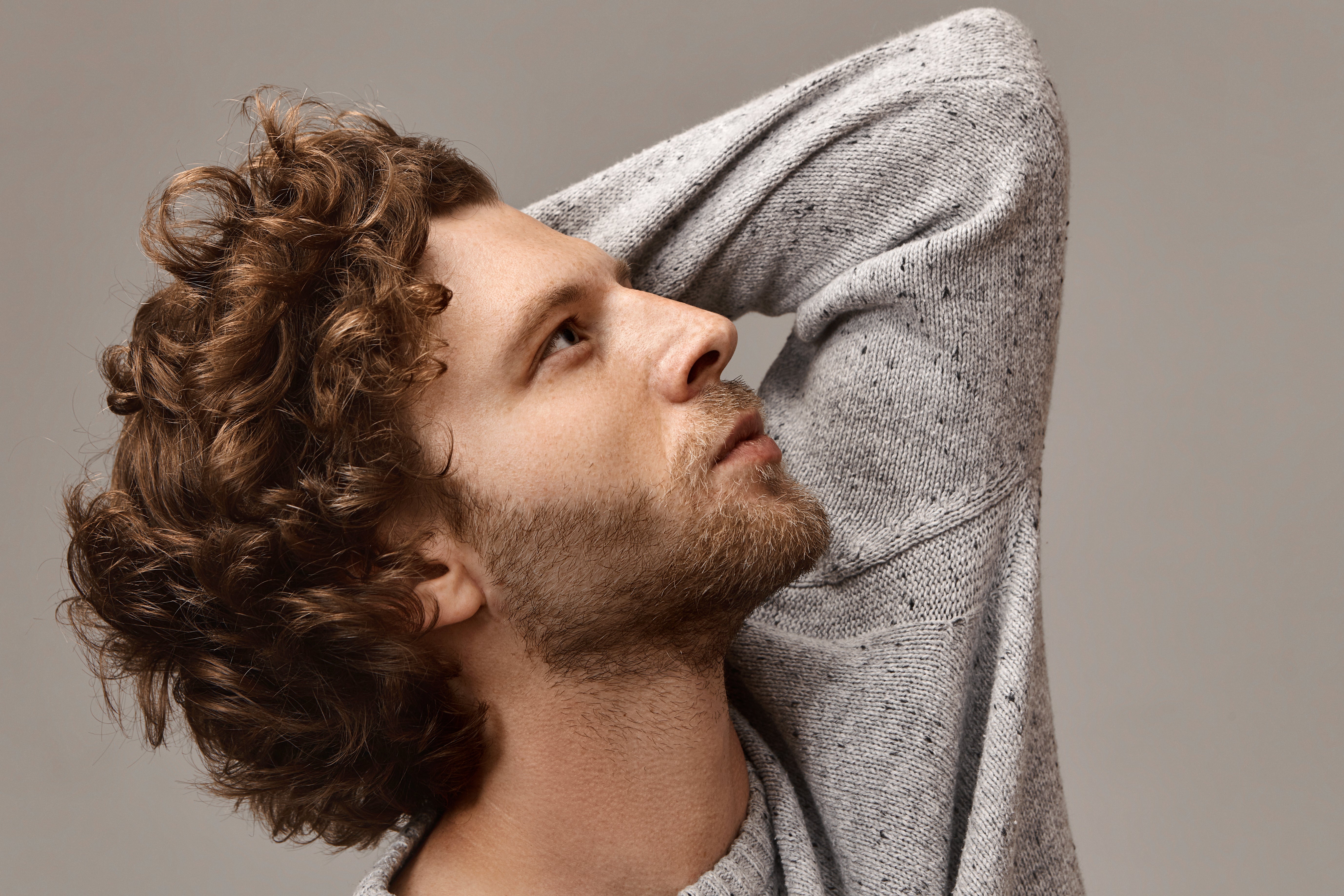 files/style-fashion-masculinity-mena-s-wear-concept-portrait-stylish-unshaven-man-with-beautiful-profile-touching-his-curly-hair-looking-up-with-thoughtful-facial-expression-wearing-gray-ju.jpg